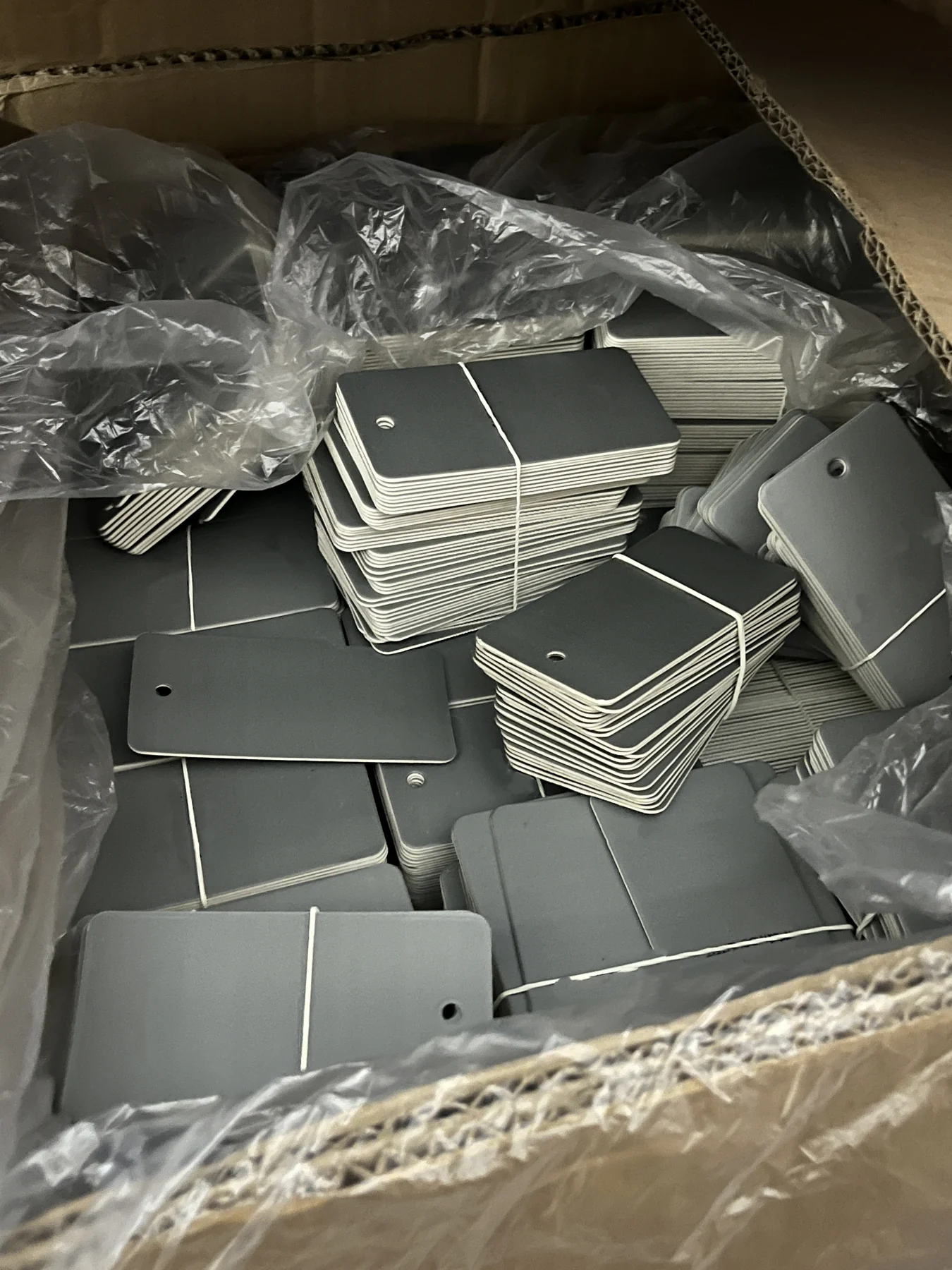 Black hangtag components prepared for private-label activewear orders