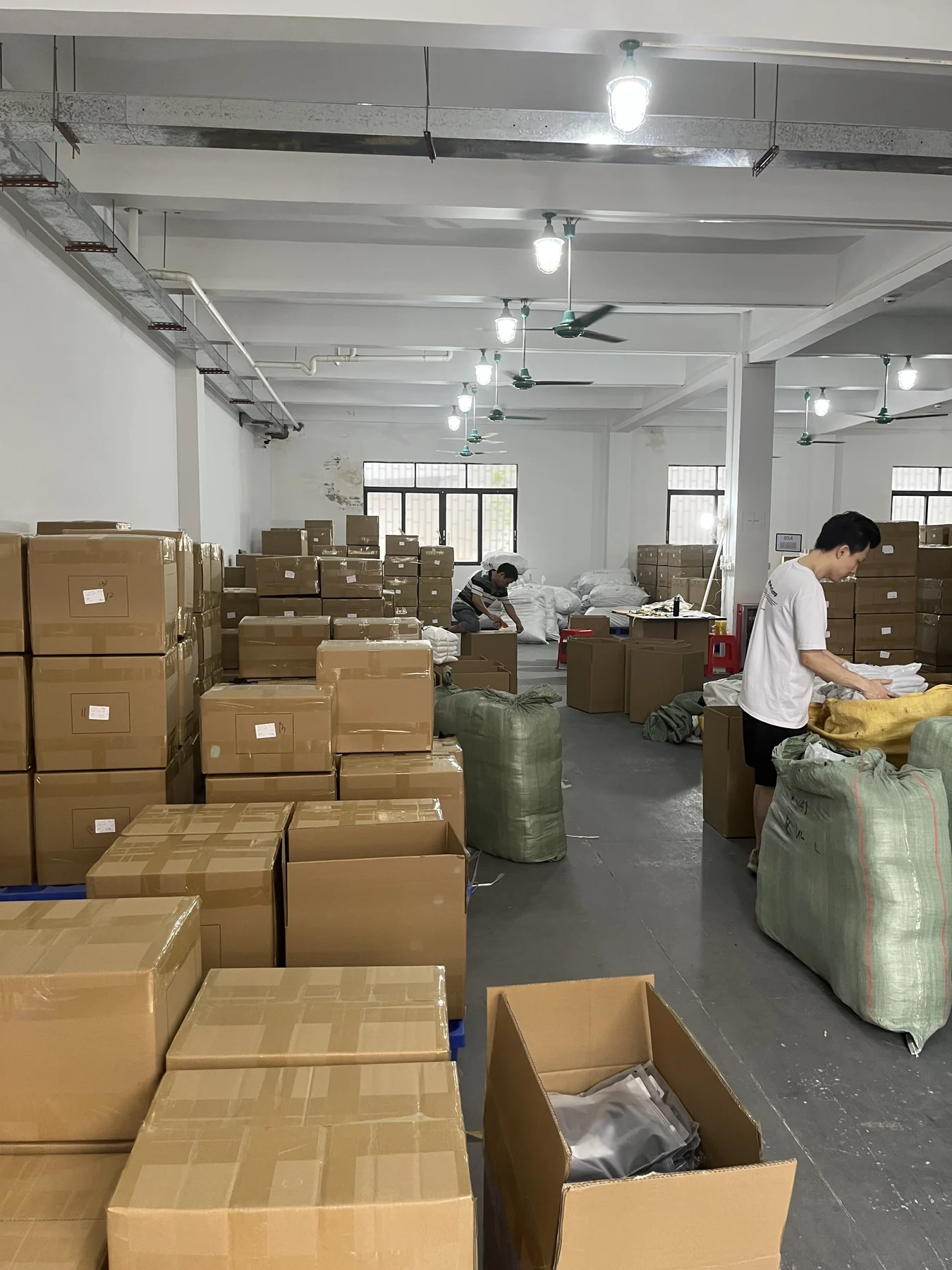 Finished activewear orders being packed into cartons in the MIQI warehouse
