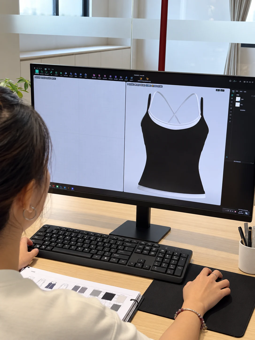 MIQI activewear designer reviewing a digital garment design reference
