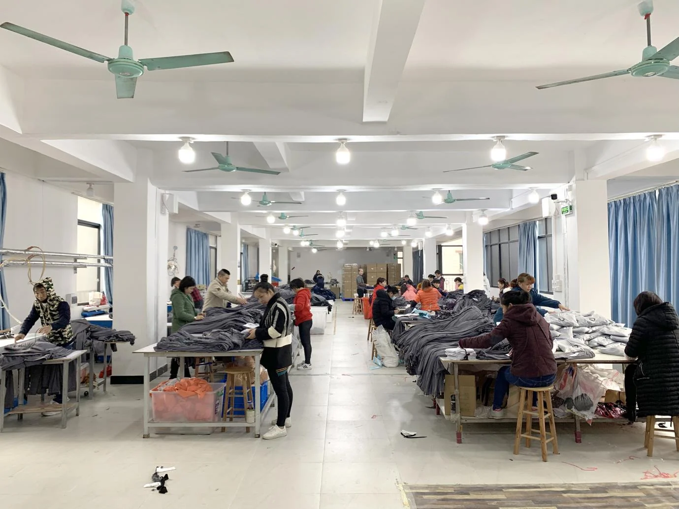 MIQI activewear production workshop with sewing teams and organized workstations