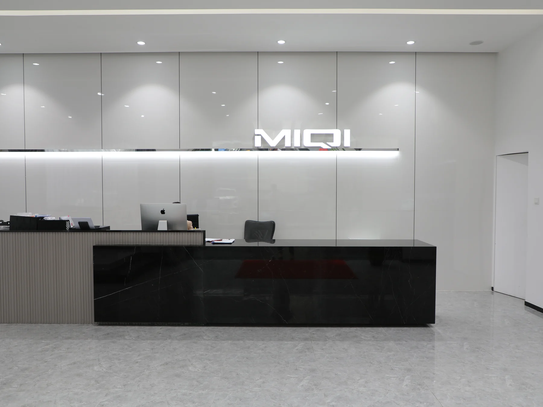 MIQI Apparel head office reception with the company logo