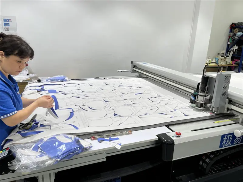 MIQI cutting technician preparing activewear pattern pieces