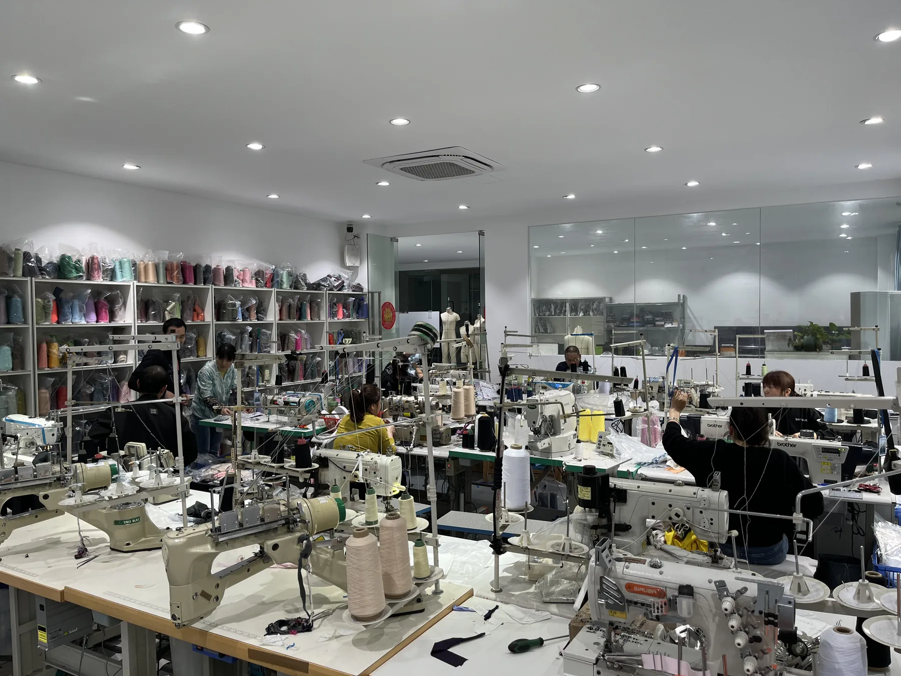 MIQI sample room with specialized sewing machines and garment technicians