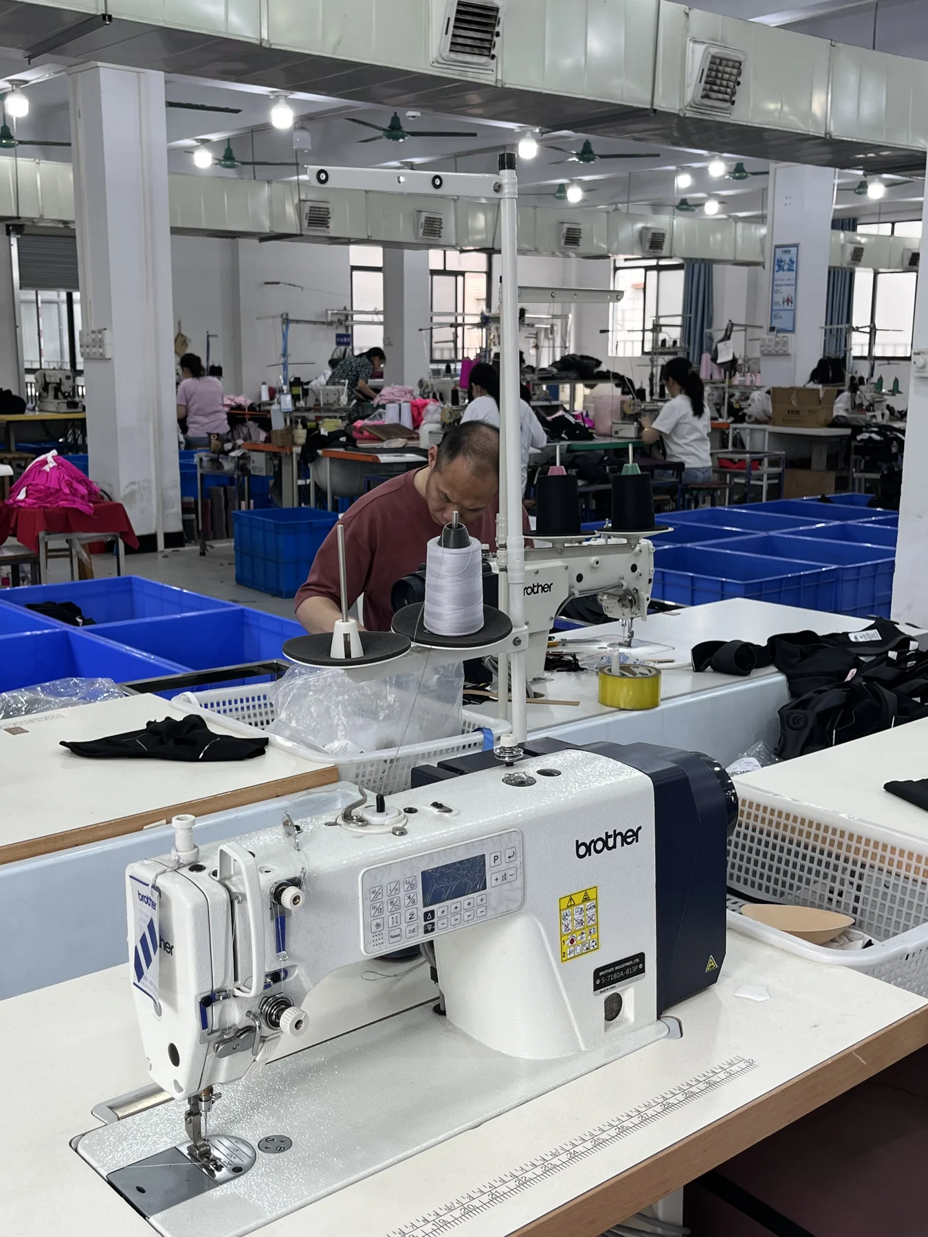 MIQI sewing operator using specialized activewear sewing equipment