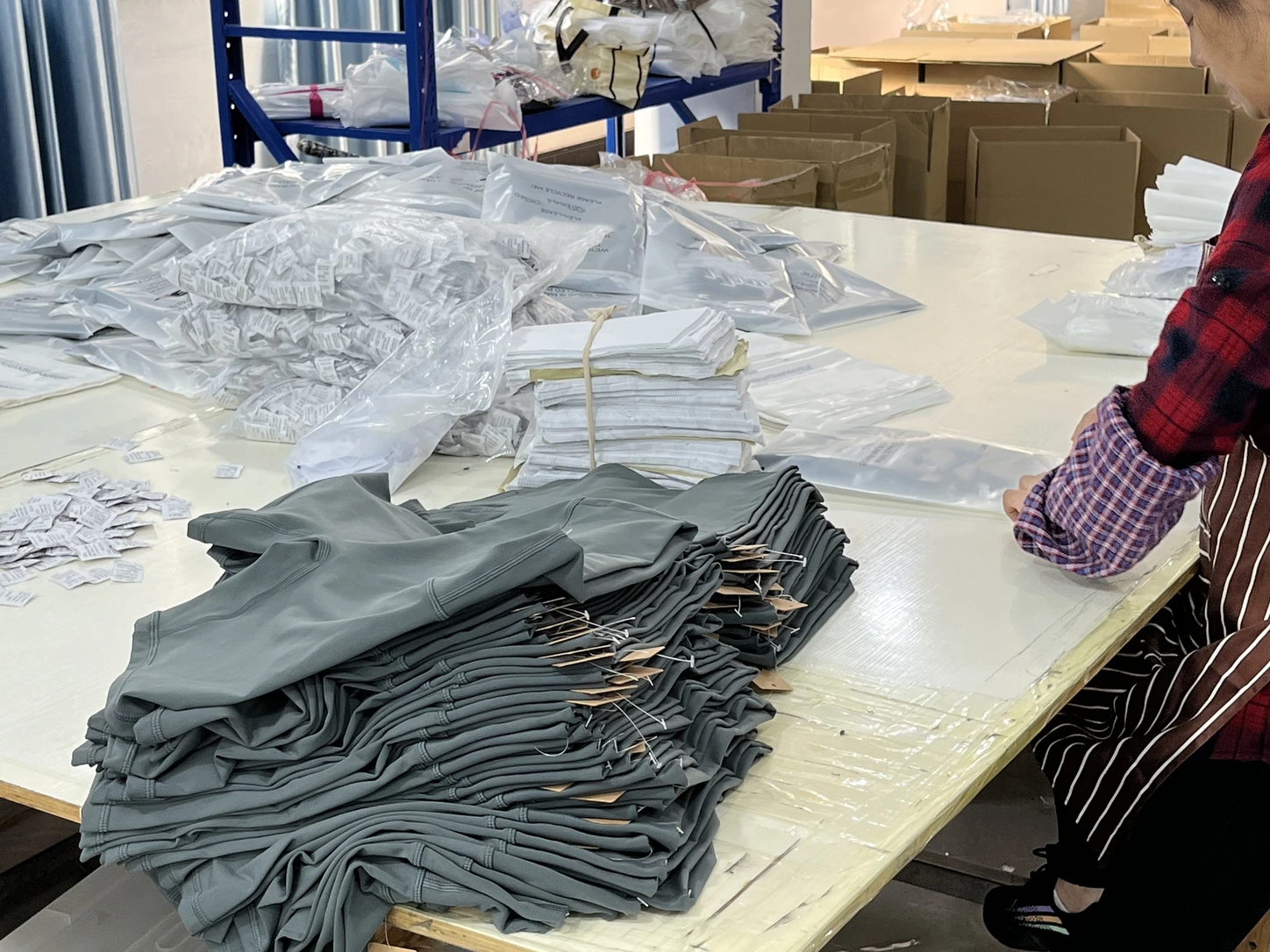 MIQI team preparing folded activewear and packaging materials
