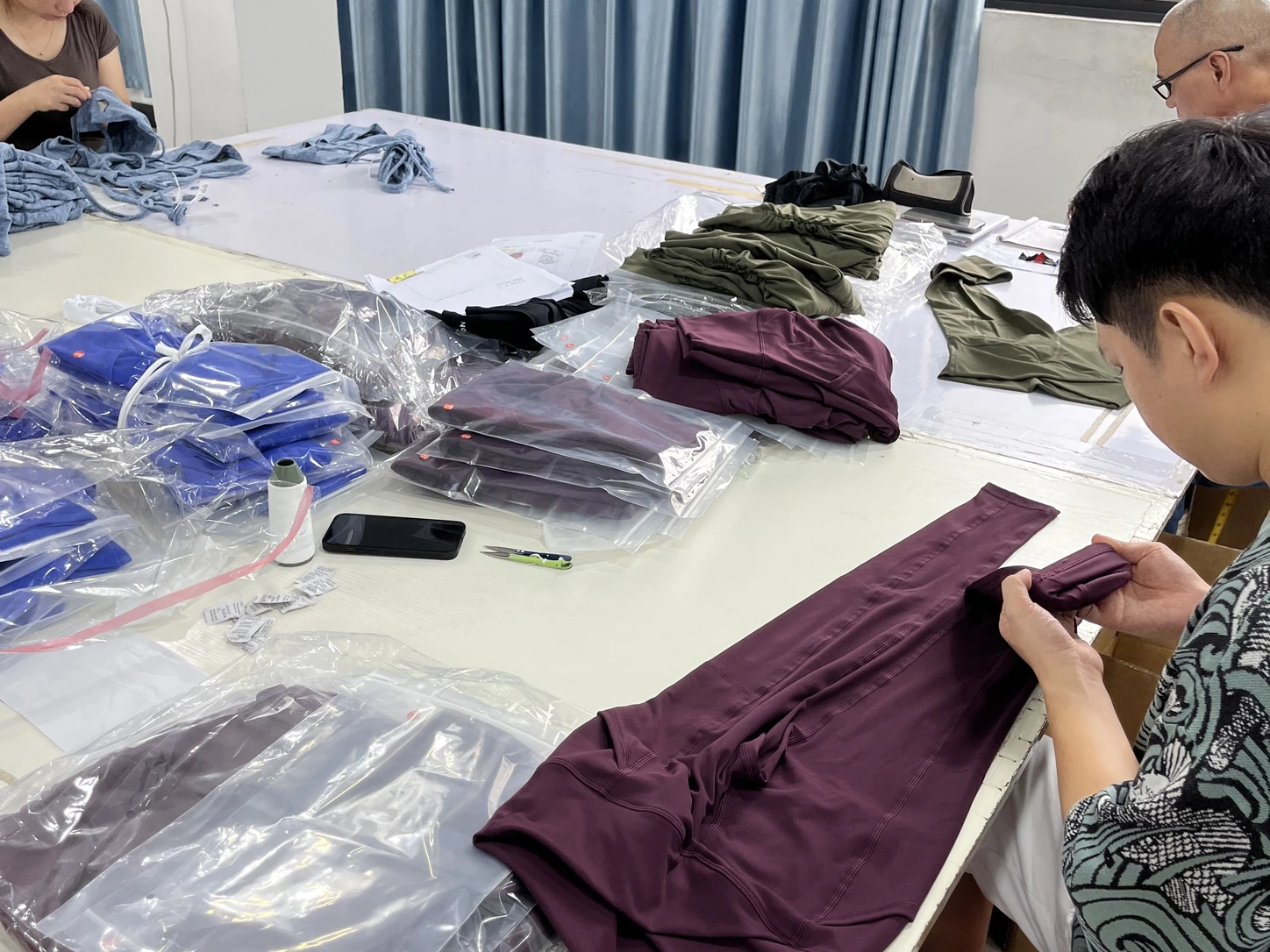 MIQI team reviewing activewear samples for fit, construction and finish approval