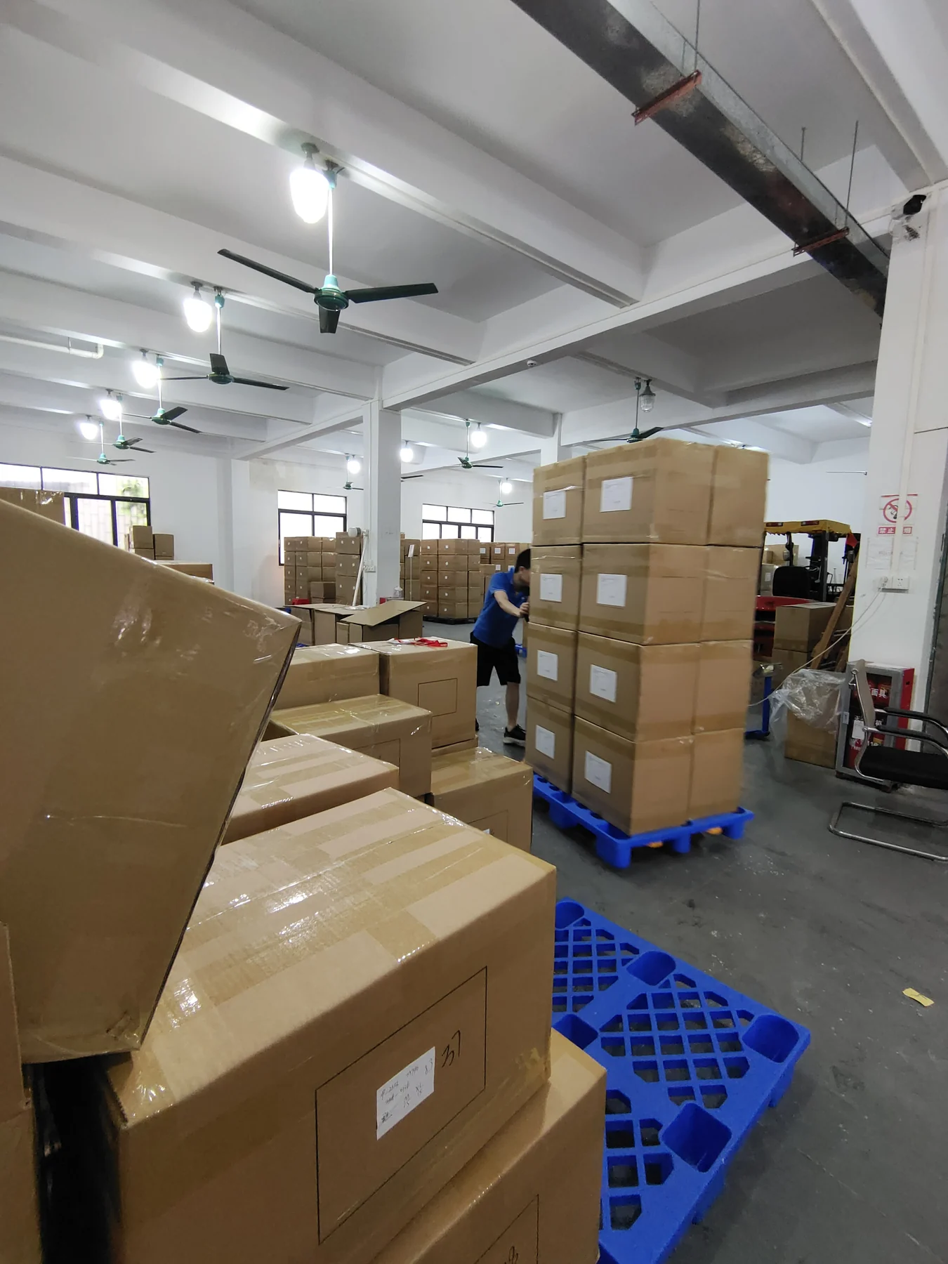 Packed activewear cartons organized in the finished-goods warehouse