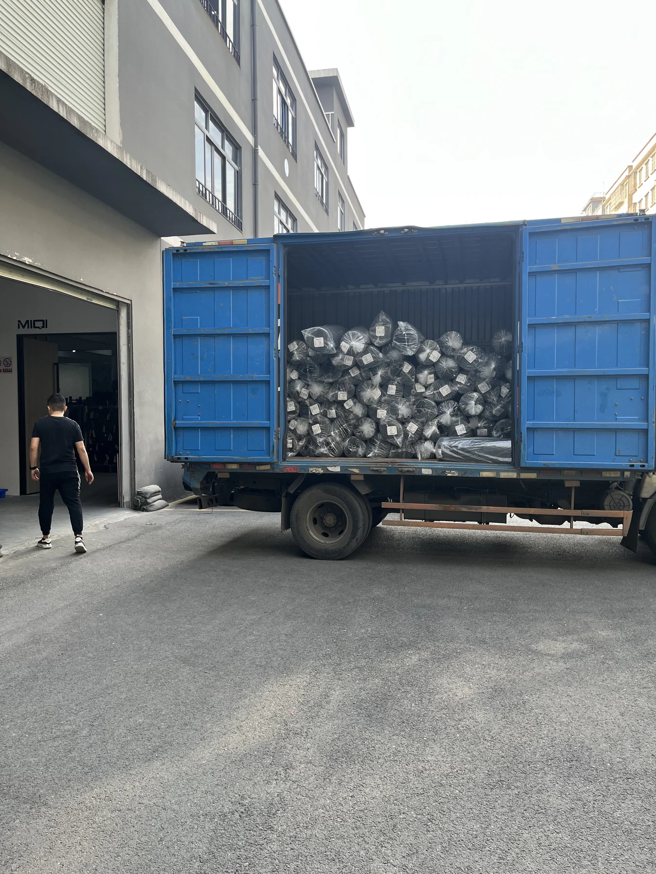 Packed MIQI activewear order loaded for shipment from the factory