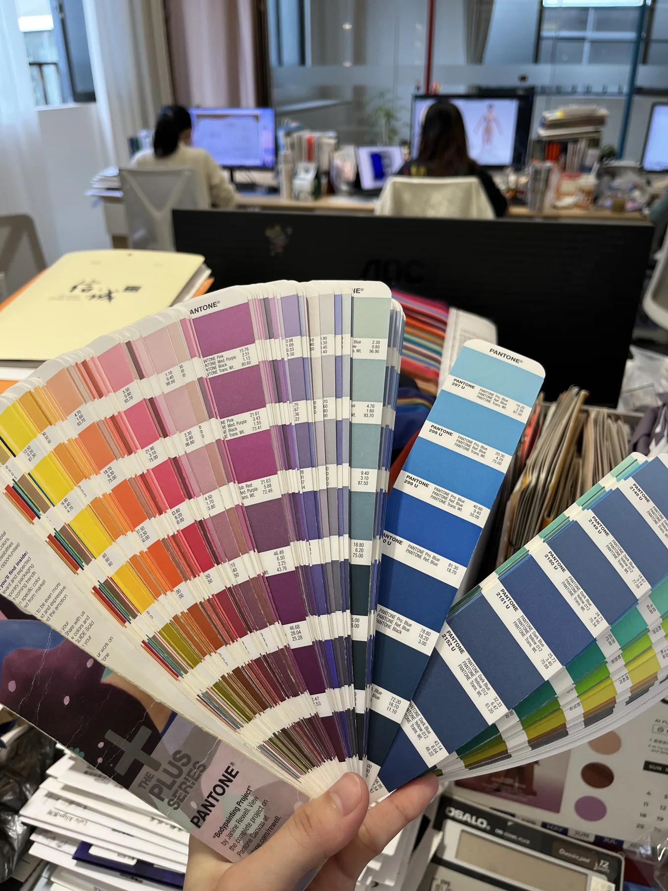 Physical Pantone colour guides reviewed at the MIQI product development office