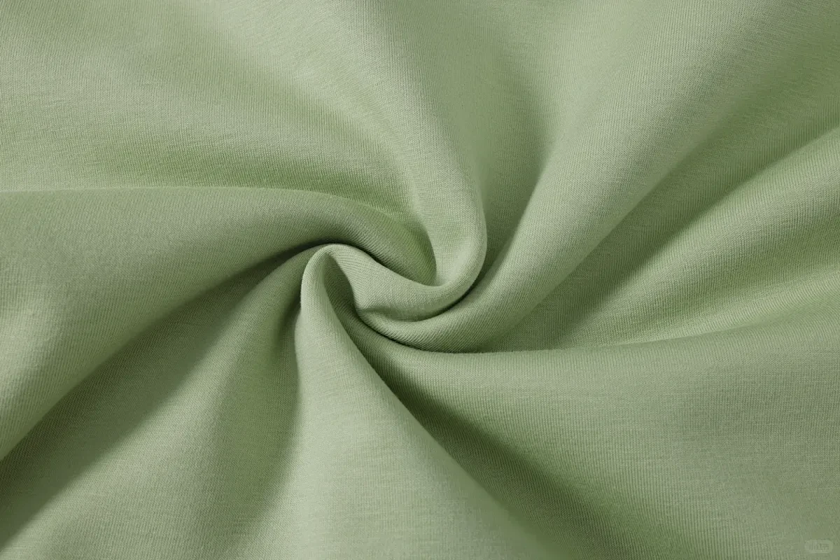 Sage green performance fabric flowing in soft folds